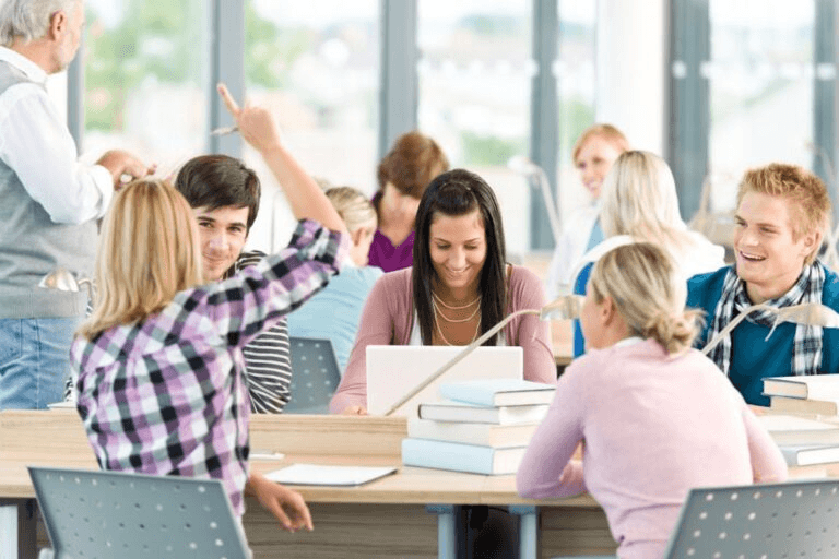 Close up of student using a tablet and laptop